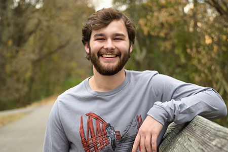 Male student outside on the Ladiga Trail